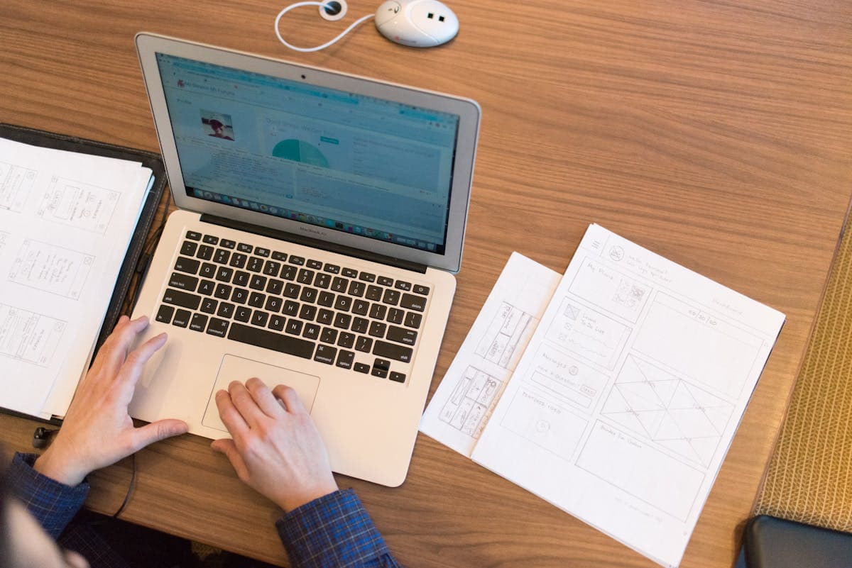 Person working on laptop comparing browser tools for workflow automation