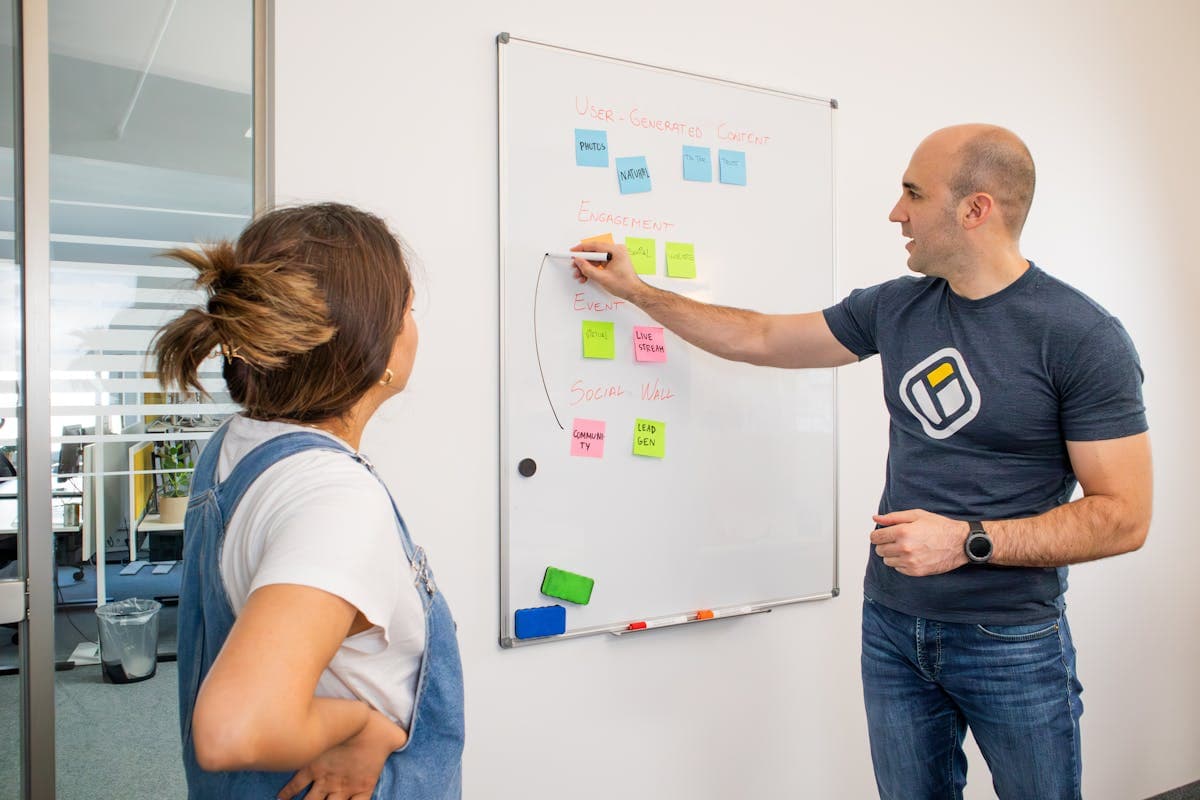 Two colleagues brainstorming lightweight automation strategy on a whiteboard